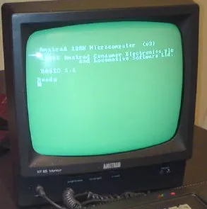 The Amstrad green-screen monitor showing the CPC startup message, "Amstrad 128K Microcomputer" and "BASIC 1.1 Ready"